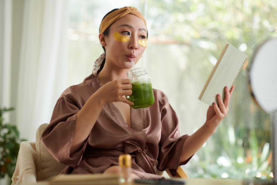 Woman drinking a green smoothie
