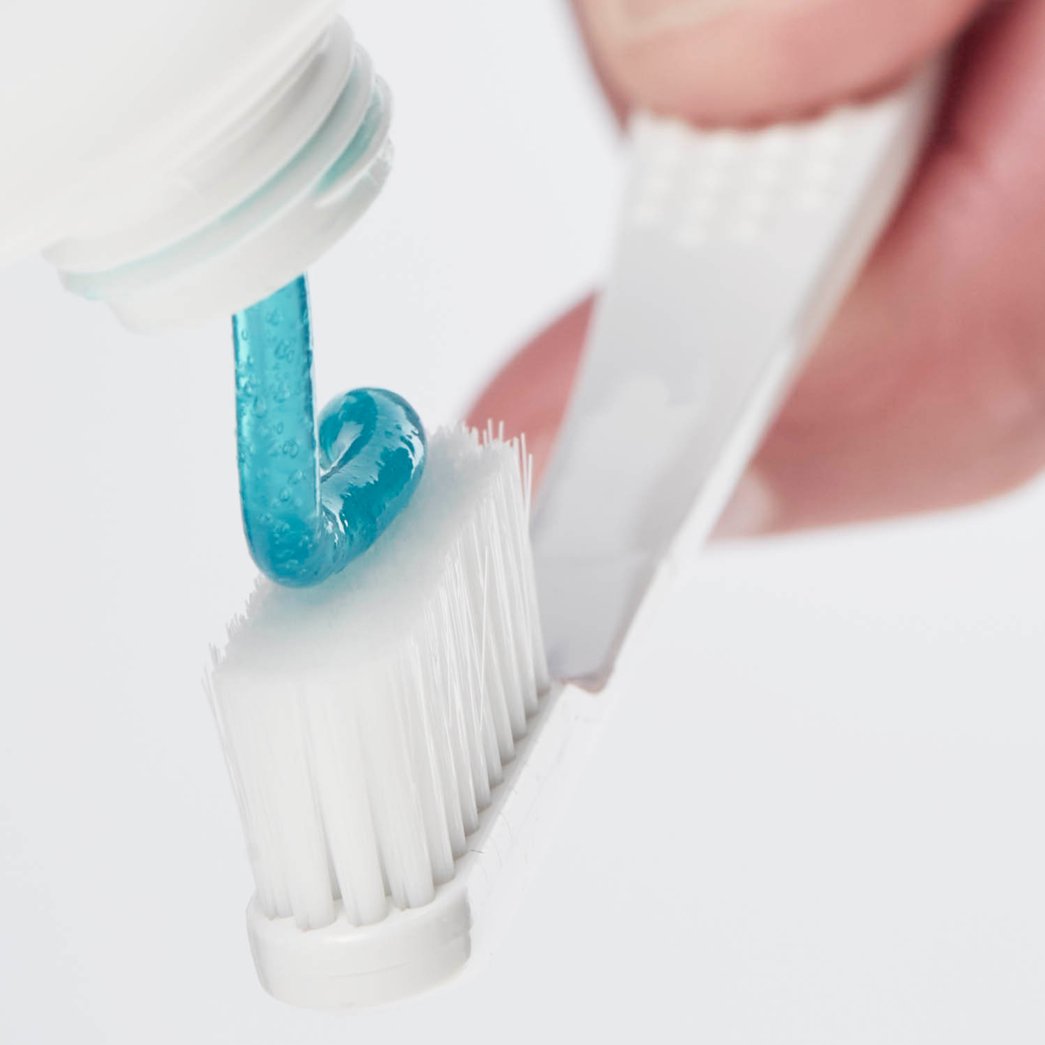 bluem Toothpaste being added to bluem Ultra Soft Toothbrush