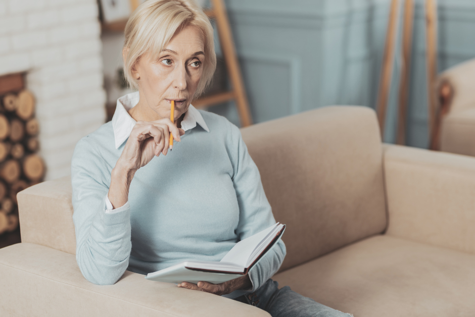 Woman biting pencil