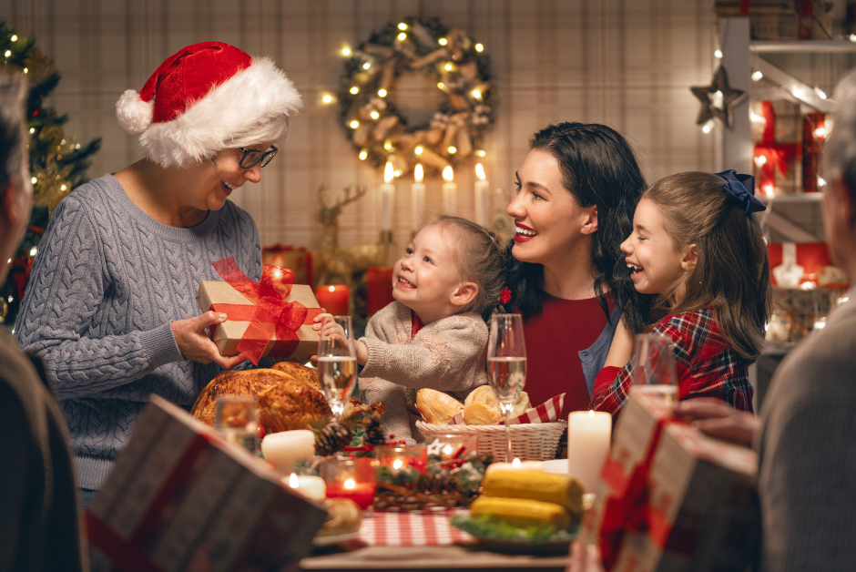 A family at a table exchanging gifts