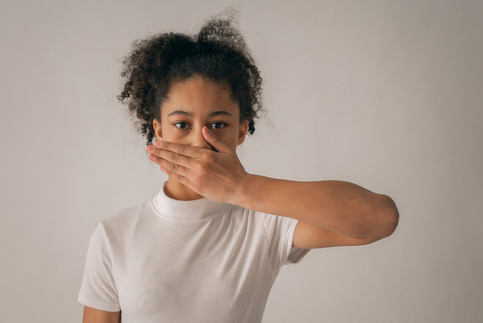 A woman holding her hand over her mouth