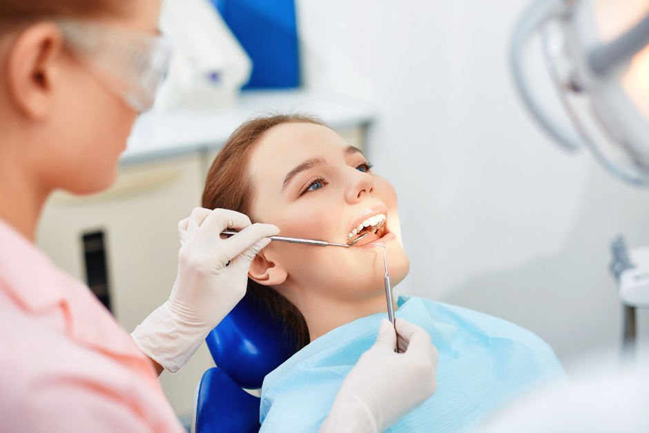 A woman getting her teeth checked by a dentist