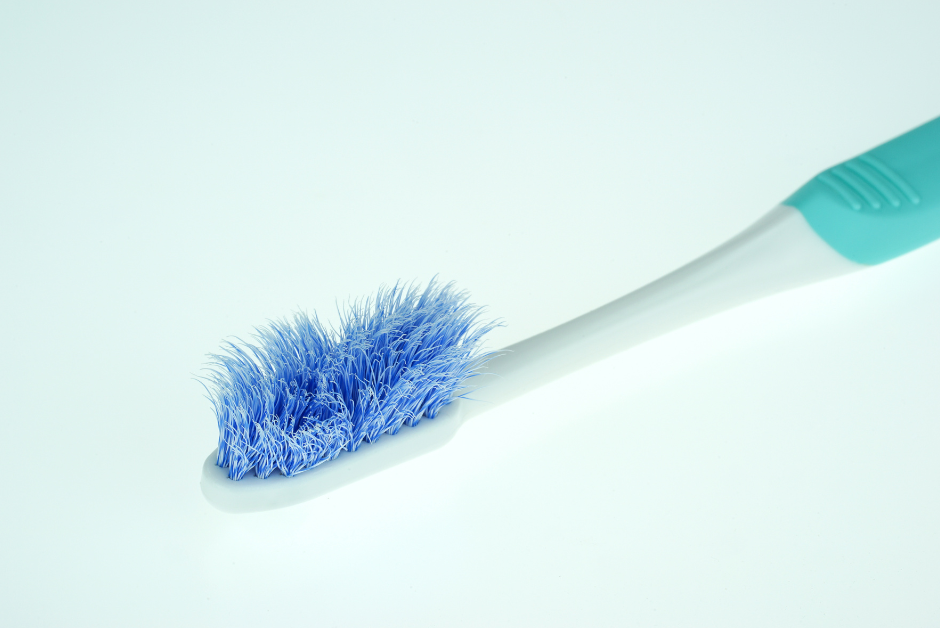 Old used toothbrush with splayed bristles